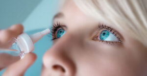 a woman applies eye drops to her dry eyes