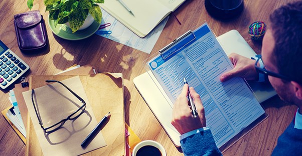 person filling out unemployment application form