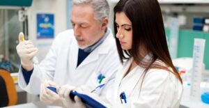 Two researchers study blood