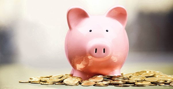 piggy bank sitting on top of coins