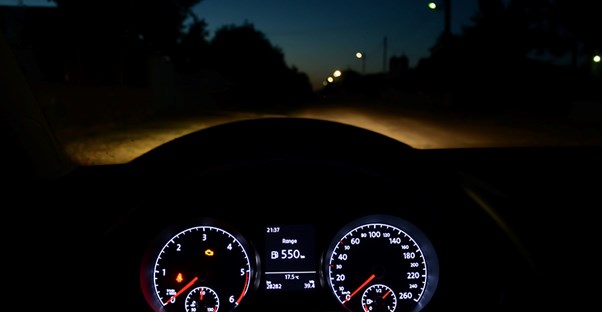 speedometer inside car driving down the road