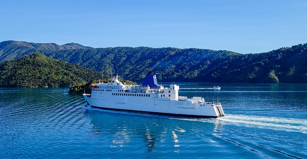A ferry floats across the clear blue waters of Bora Bora.