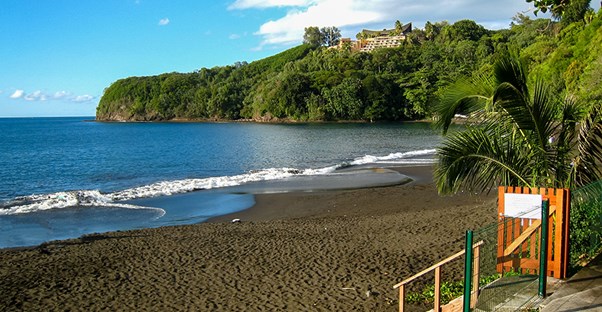 A landscape view of the dark black beaches of Tahiti.