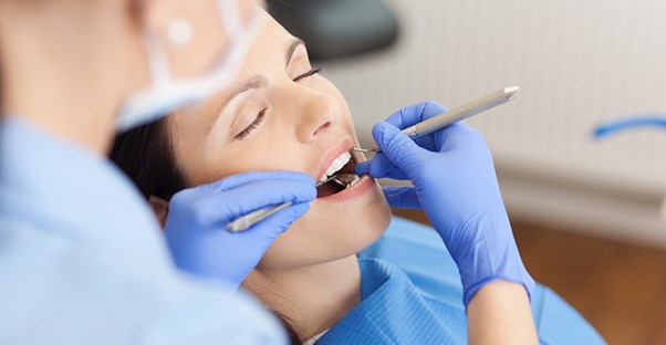 A woman has her teeth cleaned