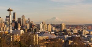 Downtown Seattle and the Space Needle are situated in front of Mount Rainier in the distance.