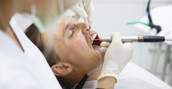 A woman has her teeth cleaned
