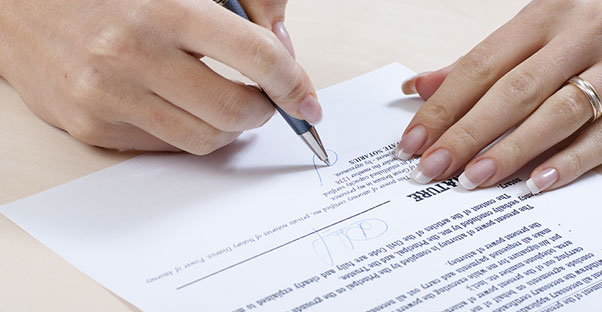 Woman signing her will
