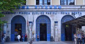 People gather in front of a blue building in a public square in the Mexico City neighborhood of Roma.