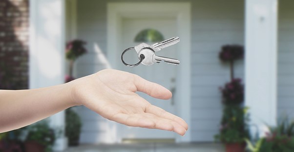 throwing keys up outside of new house to flip