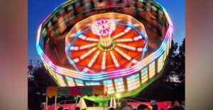 A gravitron lights up at night during the Texas State Fair.
