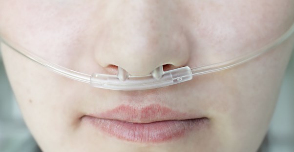 a woman wears an oxygen supply to help with her COPD