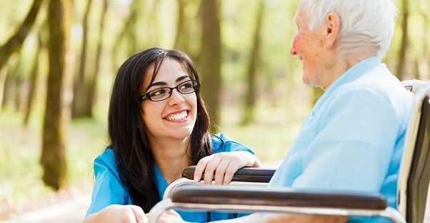 a nurse assists an aging alzheimers patient