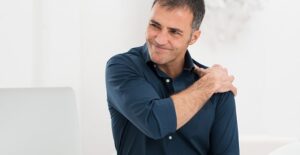Man with shoulder pain at desk