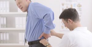 Doctor inspecting man's pinched nerve