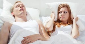 Man snoring in bed