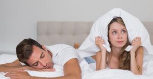 Man snoring in bed