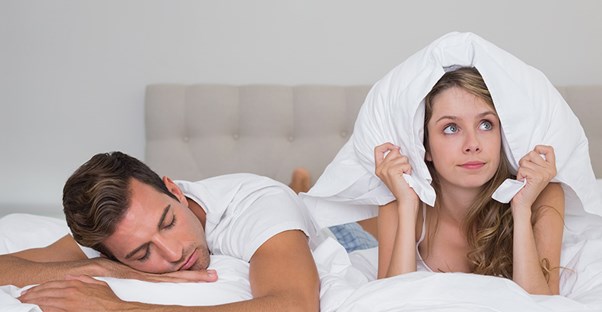 Man snoring in bed