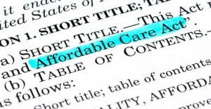 Printed information on white paper with affordable care act highlighting in blue