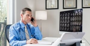 doctor sitting at desk classifying a coma