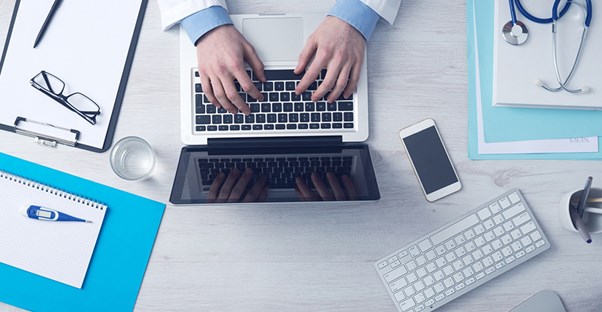 doctor on computer looking up coma treatments
