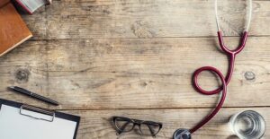 stethoscope and glasses on doctor's desk