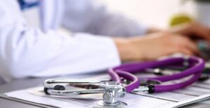 doctor sitting at desk researching fibromyalgia causes
