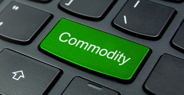 computer keyboard close up shot of a green button that says commodity on it to show you can search for the best broker online