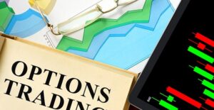 A pair of reading glasses and a book titled Options Trading laying on top of several graphs showing the difference in call vs. put options