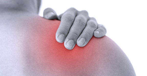 guy holding shoulder because he is experiencing chronic pain
