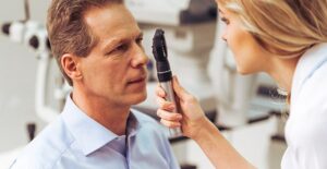 eye doctor examining eyes looking for the cause of strabismus