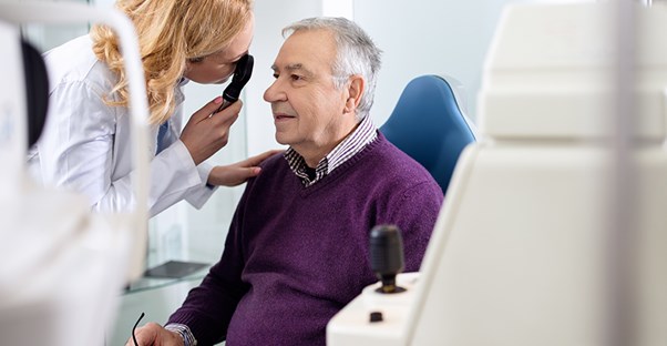man being examined by eye doctor to see if he has strabismus