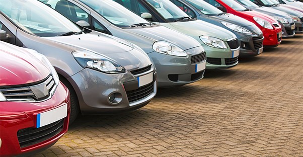 a row of various cars parked like they are lined up for auction