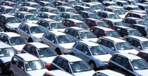 A view from slightly above of a lot of vehicles lined up and ready for an auto auction