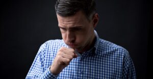 guy coughing and needing a treatment