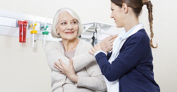 woman with physical therapist getting treatment for myofascial pain syndrome