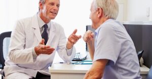 doctor and patient discussing the risk factors of myofascial pain syndrome