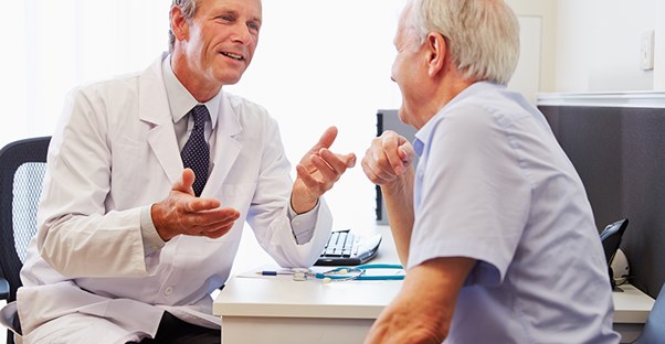 doctor and patient discussing the risk factors of myofascial pain syndrome