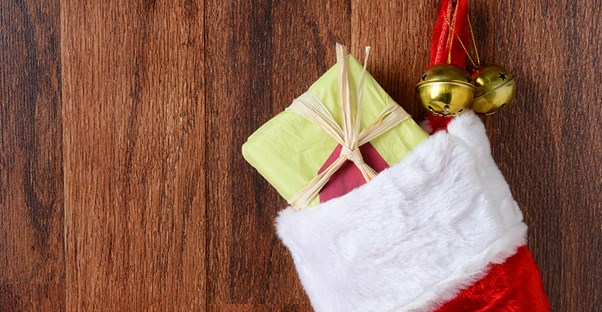 A red Christmas stocking is filled with gifts.