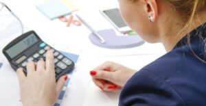investment banker calculating different types of investment accounts