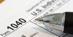 1040 Tax Return File with a pen on top to fill it out with