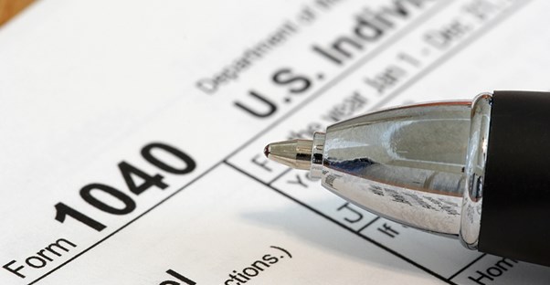 1040 Tax Return File with a pen on top to fill it out with