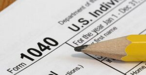 1040 filing income tax form with a pencil on top