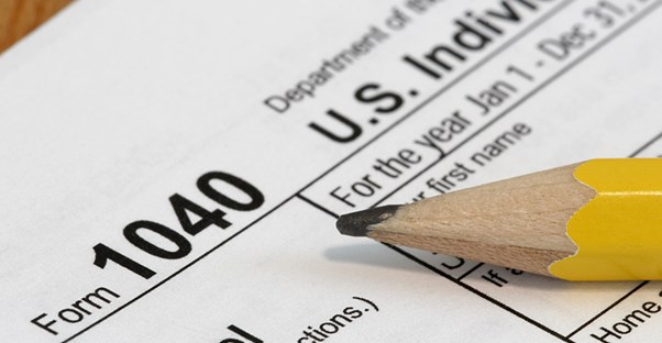 1040 filing income tax form with a pencil on top