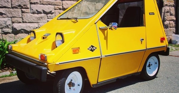 a small yellow vanguard sebring citicar
