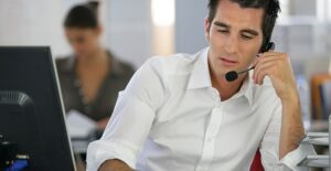 a man taking a phone call in a business call center