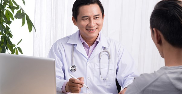 a doctor discusses overactive bladder symptoms with his patient