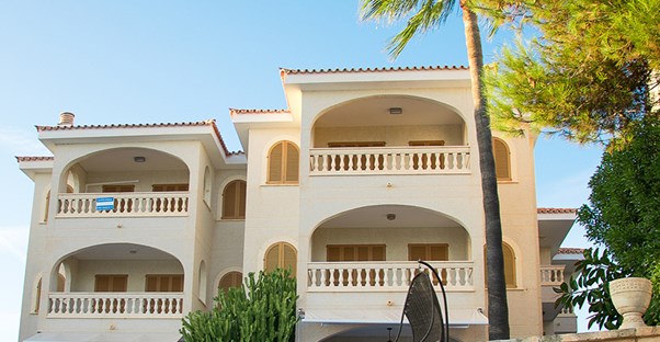 a hotel and condo building on the beach that is part of one of the top timeshare companies