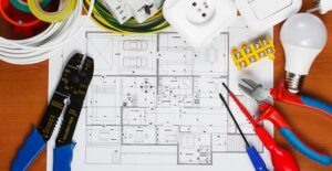 An electrician looks over a blueprint