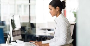 A secretary types away at her desk