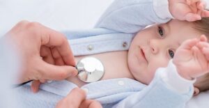 A pediatrician monitors a babys heartbeat